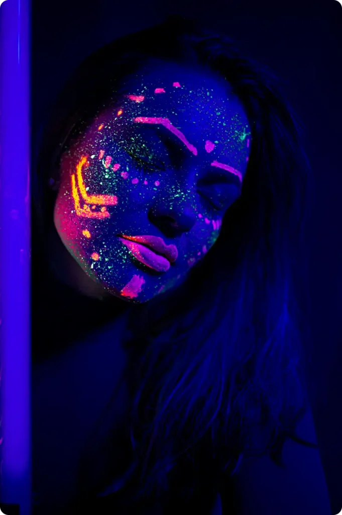 neon face paint glowing under blacklight