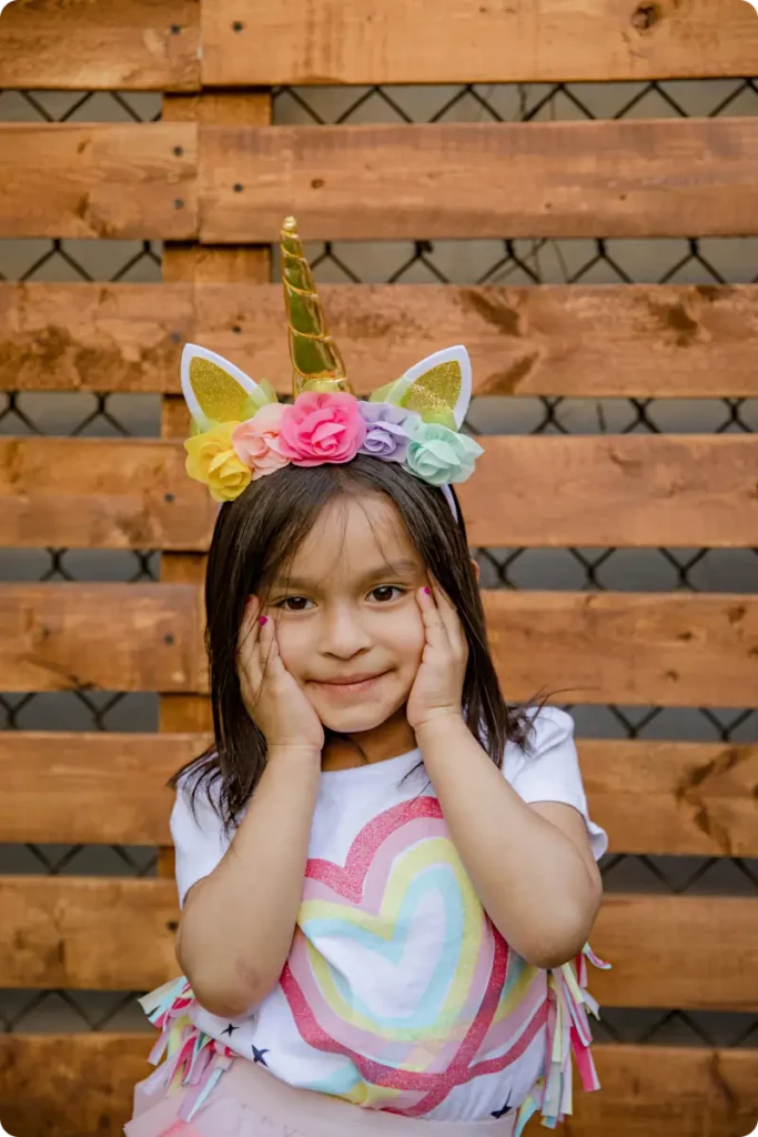 girl at party with unicorn hat