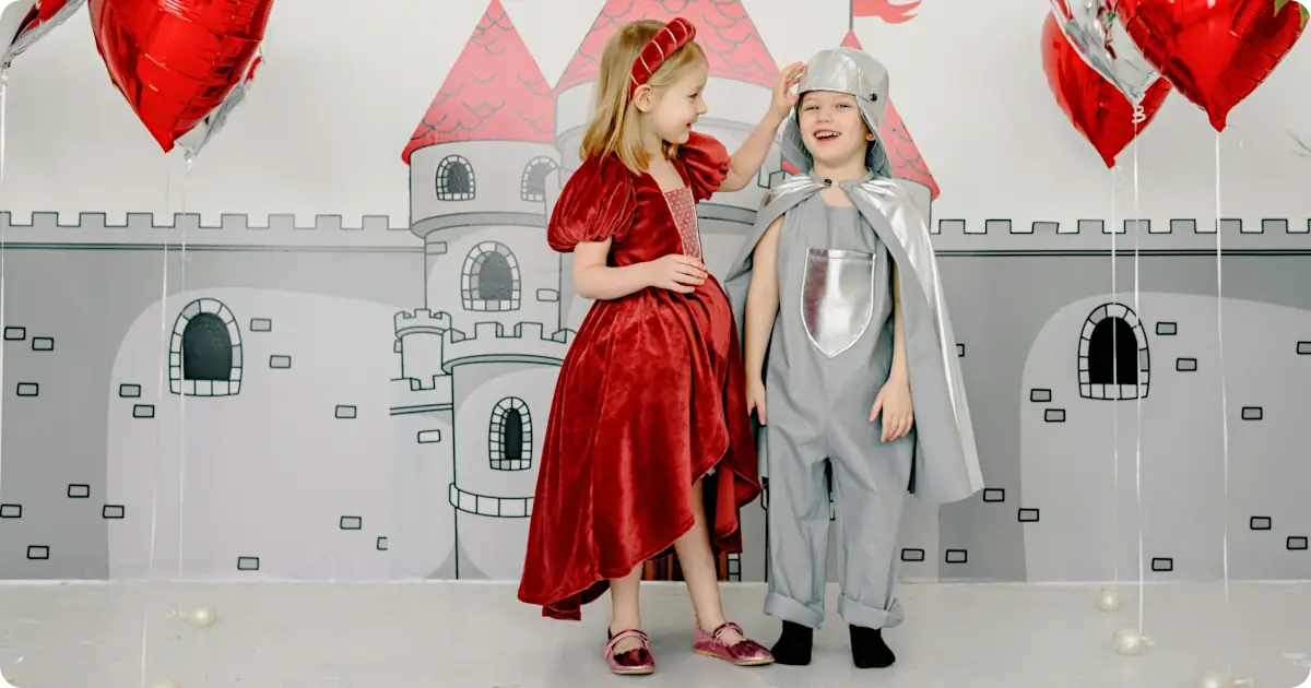 Kids with a castle backdrop at a princess birthday party