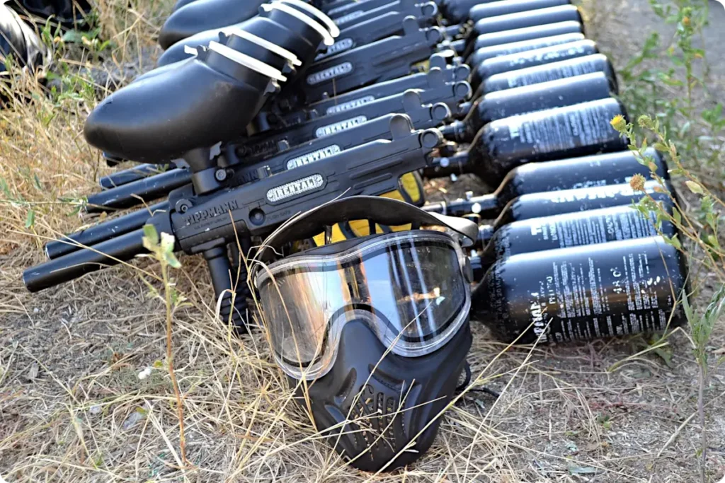 paintball game equipment including markers and safety mask
