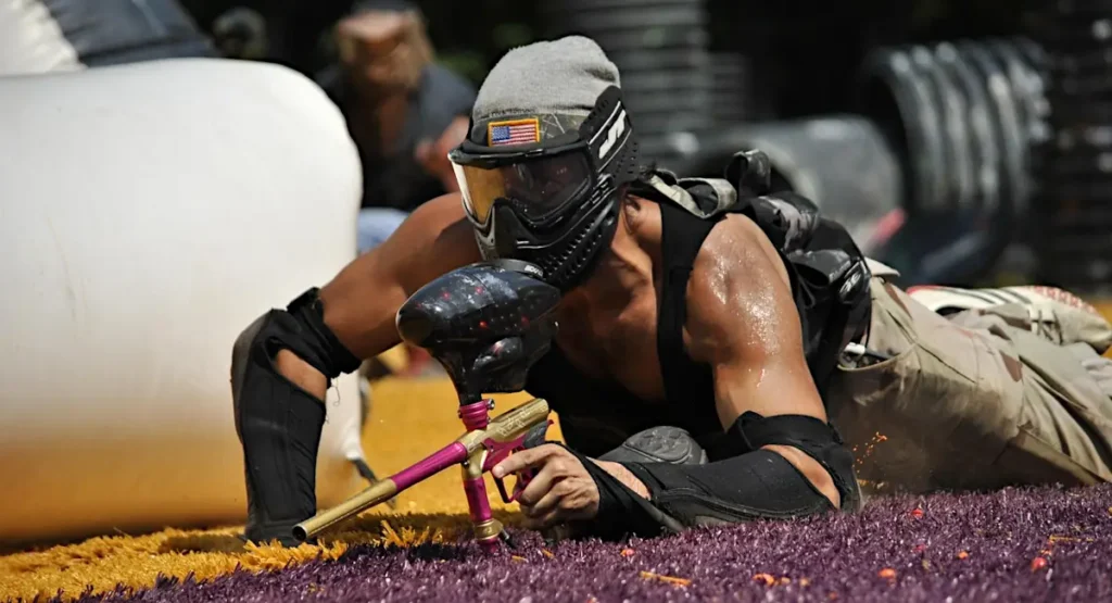 paintball player doing leopard crawl during game